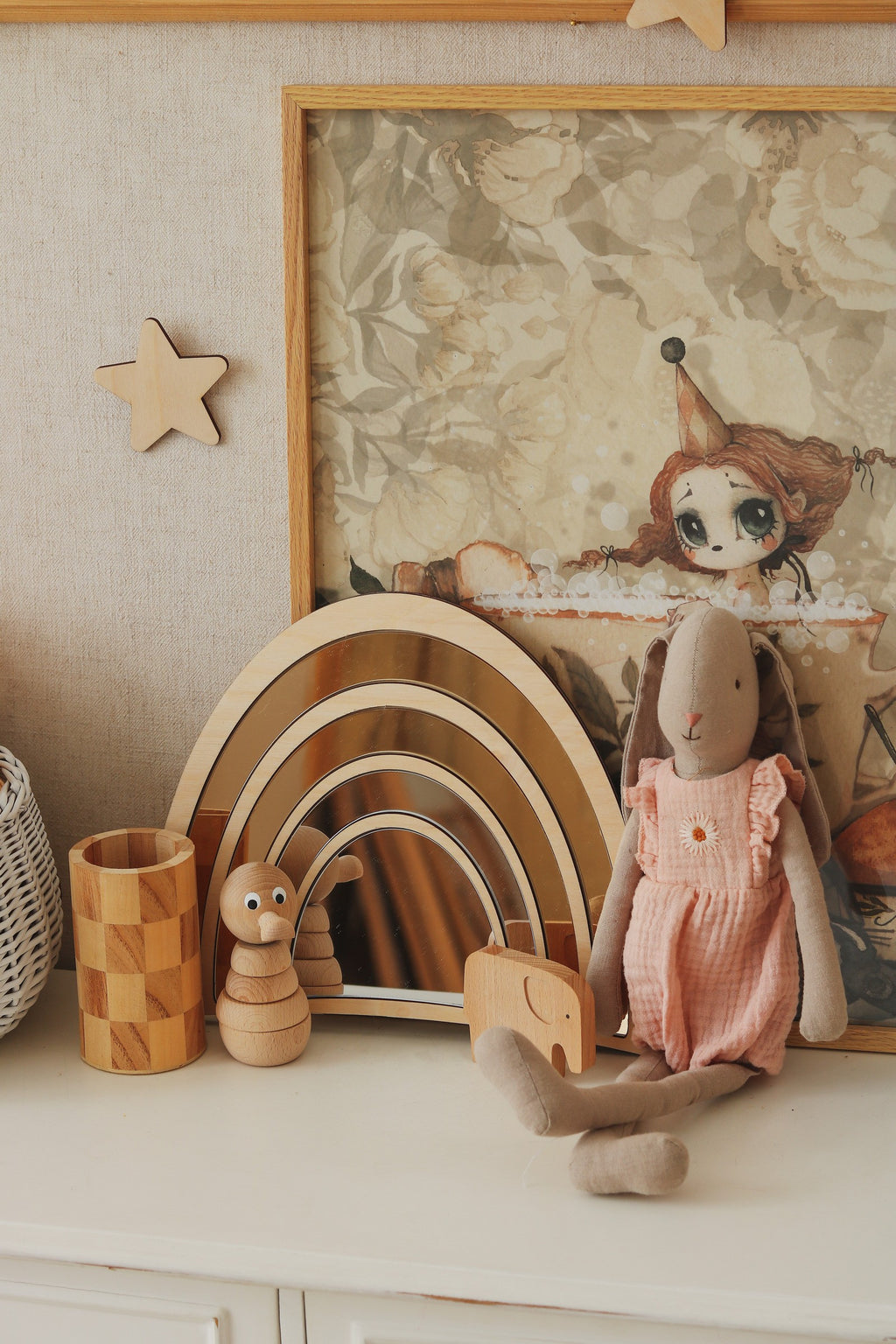 Soft handmade pale pink teddy-patterned blanket draped on a chair in a cozy nursery setting